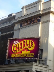An external shot of the Royal Drury Lane Theatre, London, with the 'Charlie and the Chocolate Factory' sign