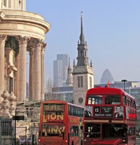 A variety of London sights and attractions in one photo, including London buses and St Paul's Cathedral